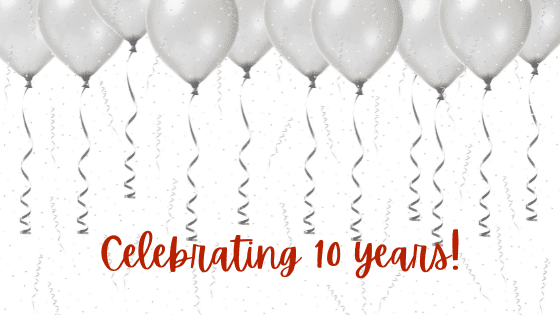 10 silver ballons float above words that say celebrating 10 years.