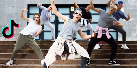 Teenagers are dancing in a synchronized manner. The TikTok logo is on the right.